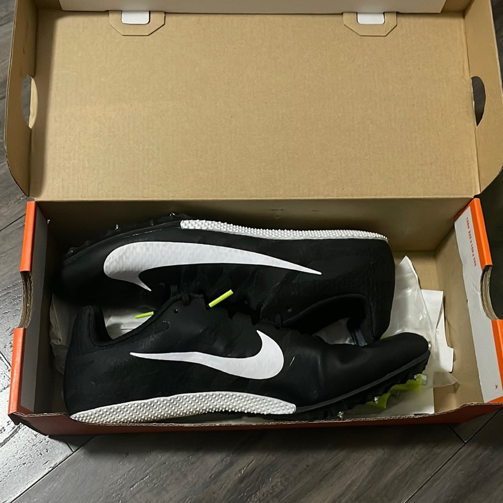 Black & White Nike track shoes w/ extra needles steel 3/16 spikes.Used one time.